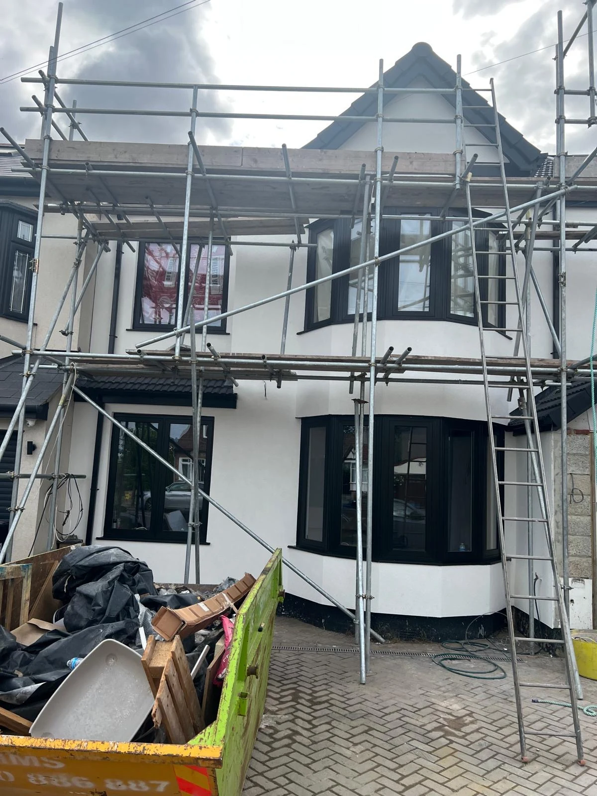 B.Atlas Construction Ltd – brick house extension with scaffolding